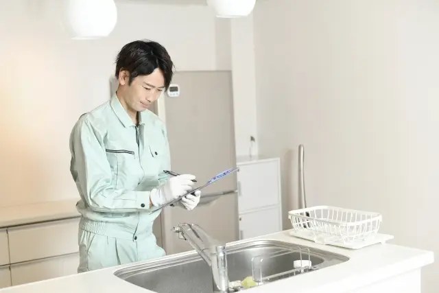 キッチンの水まわりを確認する作業員
